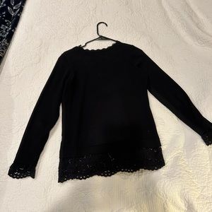 Black long sleeve shirt with lace cuffs and base.